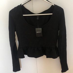 Long sleeve crop top with a ruffle.